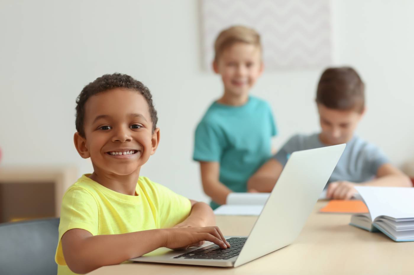 Smiling child with a laptop