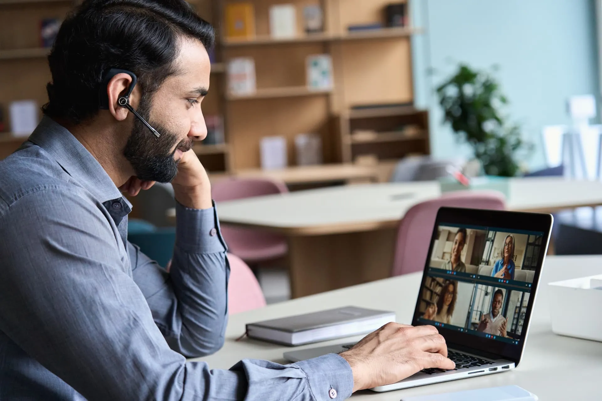 A support worker talking to teachers in a video call.