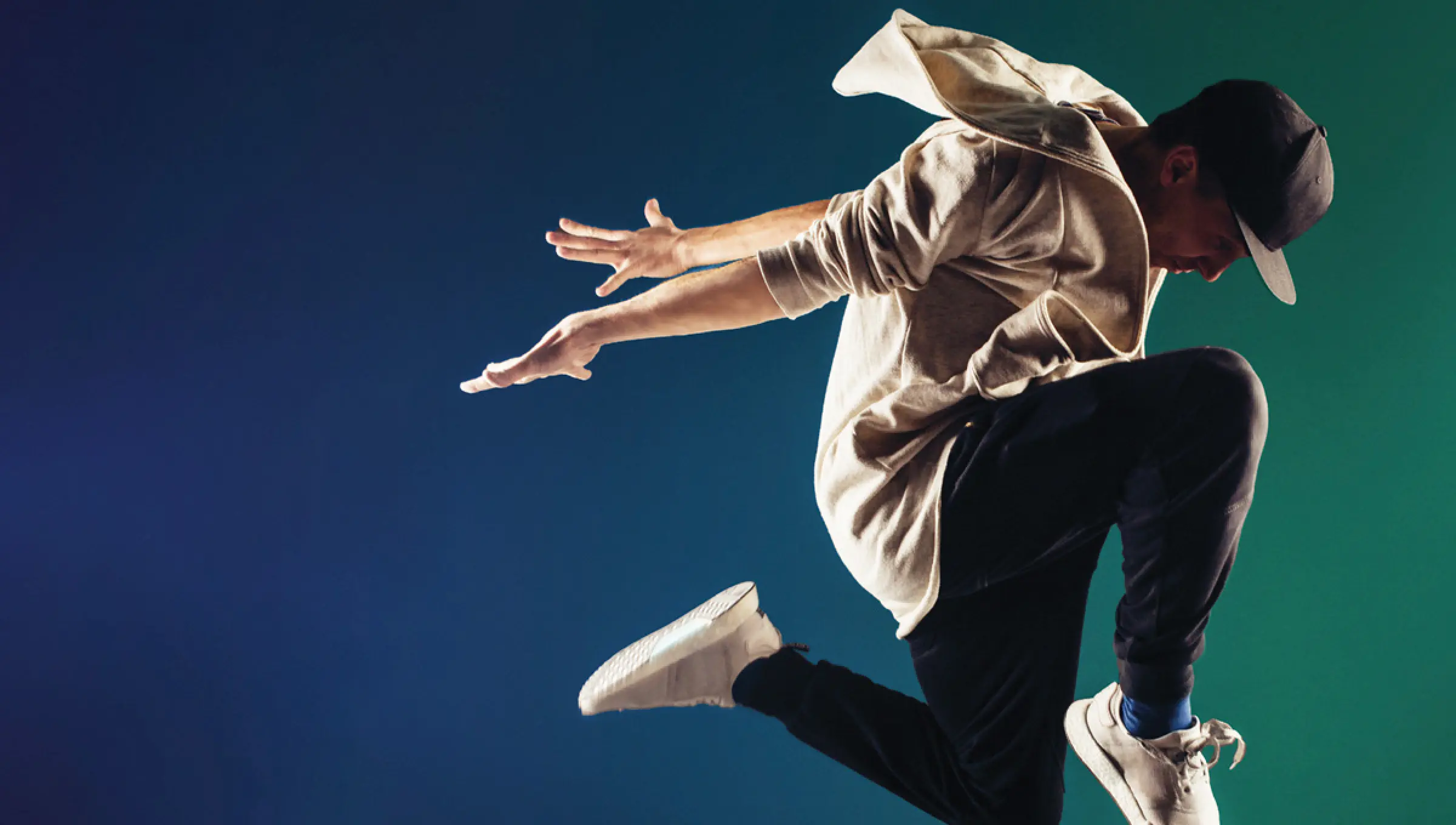 A dancer posing on a blue and green background