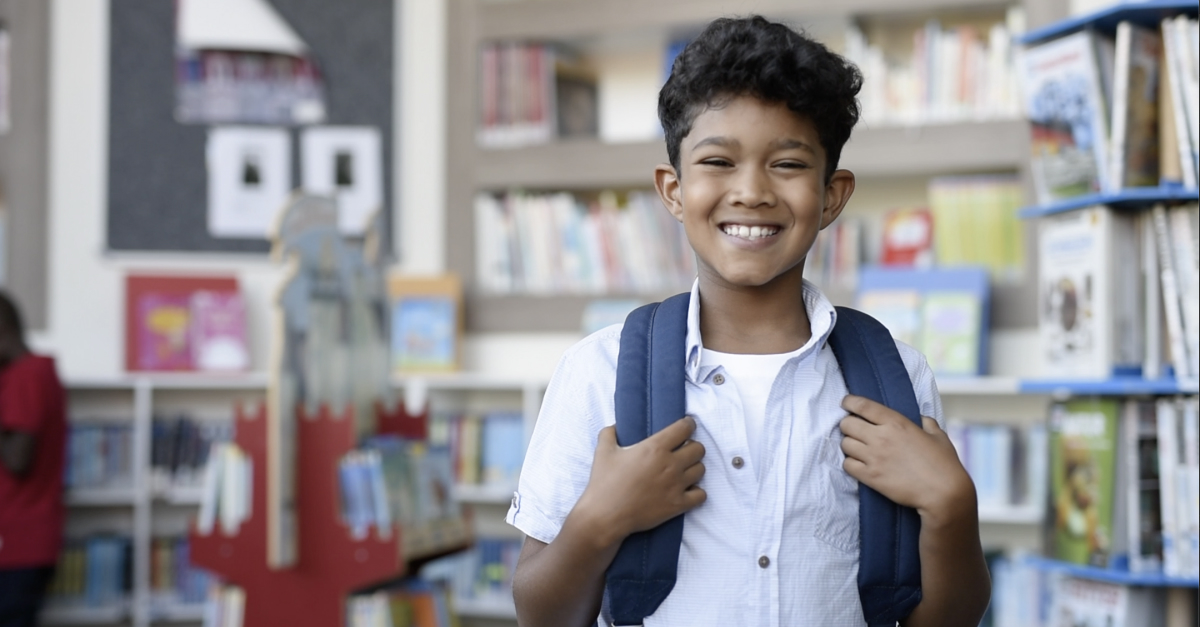 A boy smiling in the library