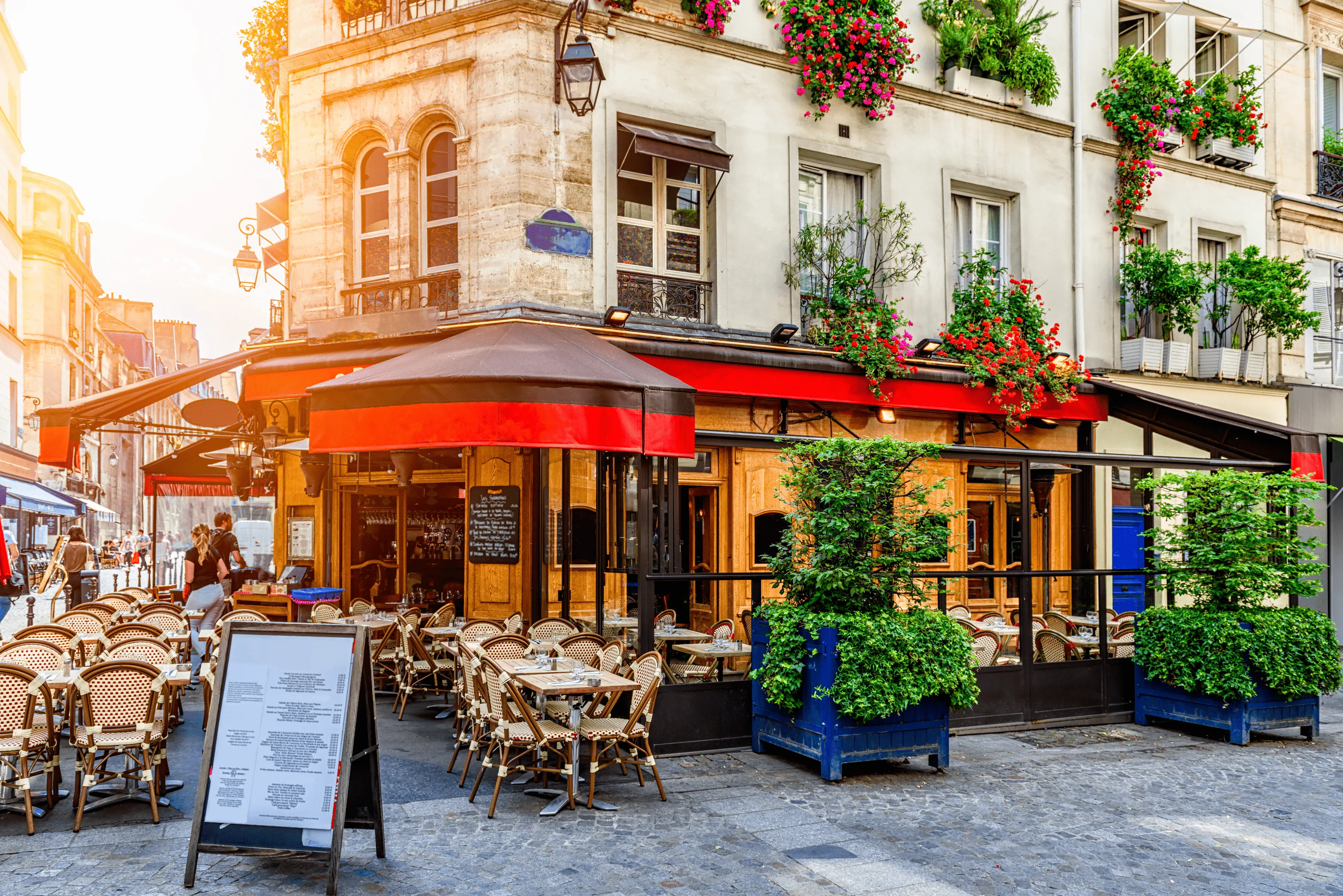 Cozy street with tables of cafe in Paris, France